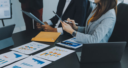 Business team meeting working with new startup project, discussion and analysis data the charts and graphs. Digital tablet, calculator, laptop computer using, Business finance and accounting concept.の写真素材