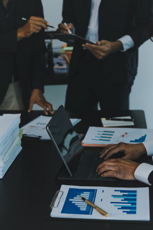 Business team meeting working with new startup project, discussion and analysis data the charts and graphs. Digital tablet, calculator, laptop computer using, Business finance and accounting concept.の写真素材