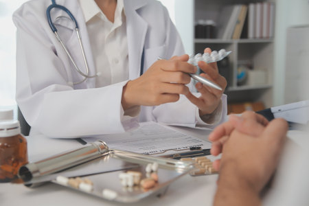 Healthcare service and pharmacy worker with customer at store counter for medication explanation. Pharmaceutical advice and opinion of pharmacist helping girl with medicine information.の写真素材