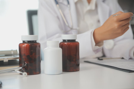 Healthcare service and pharmacy worker with customer at store counter for medication explanation. Pharmaceutical advice and opinion of pharmacist helping girl with medicine information.の写真素材
