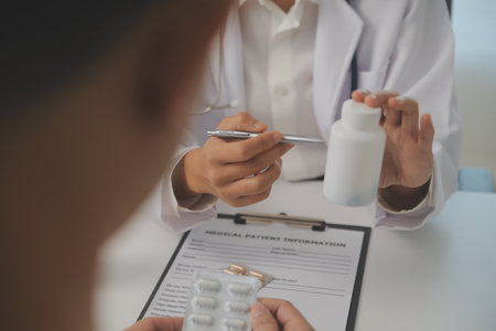 Healthcare service and pharmacy worker with customer at store counter for medication explanation. Pharmaceutical advice and opinion of pharmacist helping girl with medicine information.の写真素材