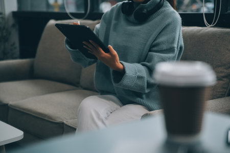 smart casual asian female startup entrepreneur small business owner business woman smile hand use tablet working organize inventory products shelf checking in showroom studio office daytime backgroundの写真素材