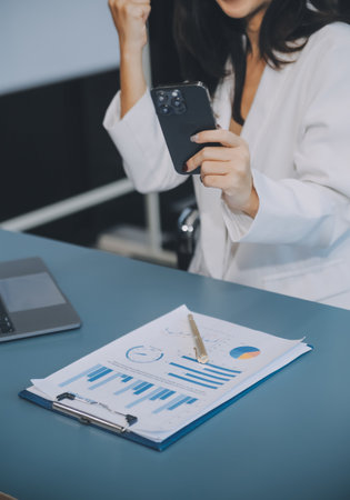 Business team working with new startup project plan and discussion information for financial strategy with laptop and digital tablet in a modern business lounge.の写真素材