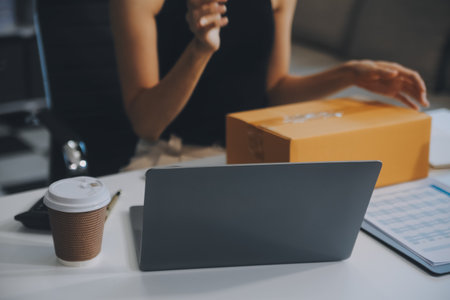 businesswoman start small business and successful SME entrepreneurs asian woman hoding boxs works from home delivering parcels online. SME delivery concept and packagingの写真素材
