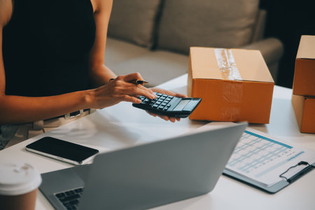 businesswoman start small business and successful SME entrepreneurs asian woman hoding boxs works from home delivering parcels online. SME delivery concept and packagingの写真素材