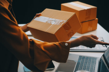 businesswoman start small business and successful SME entrepreneurs asian woman hoding boxs works from home delivering parcels online. SME delivery concept and packagingの写真素材