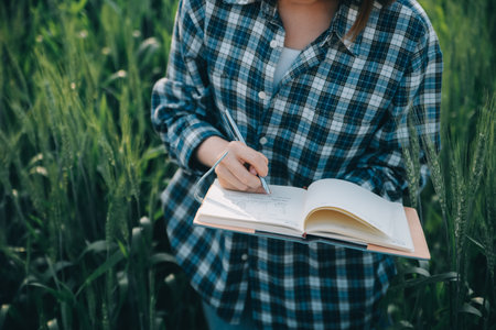 Smart farm. Farmer with tablet in the field. Agriculture, gardening or ecology concept. Harvesting. Agro business.の写真素材