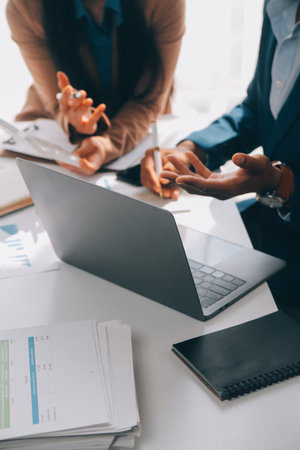 Business team working with new startup project plan and discussion information for financial strategy with laptop and digital tablet in a modern business lounge.の写真素材