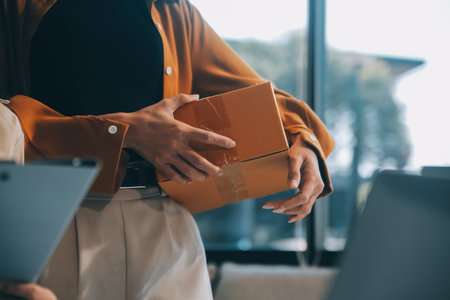 businesswoman start small business and successful SME entrepreneurs asian woman hoding boxs works from home delivering parcels online. SME delivery concept and packagingの写真素材