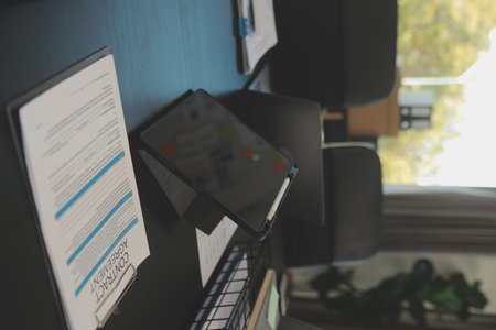 Laptop on a desk in an open financial office.