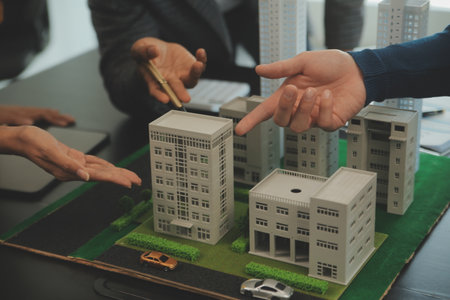 Team of architectures and businessmen discussing and brainstorming on floor plan modification for...