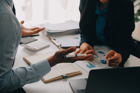 Business team working with new startup project plan and discussion information for financial strategy with laptop and digital tablet in a modern business lounge.の写真素材
