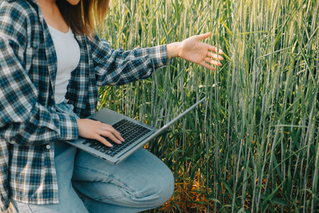 Smart farm. Farmer with tablet in the field. Agriculture, gardening or ecology concept. Harvesting. Agro business.の写真素材