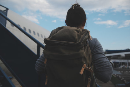 Happy attractive asian woman traveler with backpack at the modern airport terminal, copy space, Tourist journey trip conceptの写真素材