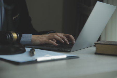 Business and lawyers discussing contract papers with brass scale on desk in office. Law, legal services, advice, justice and law concept picture with film grain effectの写真素材