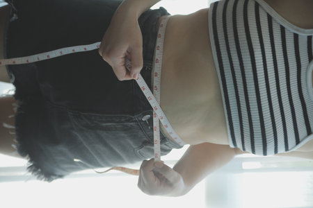 Women body fat belly. Obese woman hand holding excessive belly fat. diet lifestyle concept to reduce belly and shape up healthy stomach muscle.の写真素材