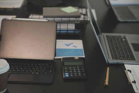 Laptop on a desk in an open financial office.の写真素材