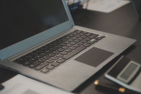 Laptop on a desk in an open financial office.の写真素材