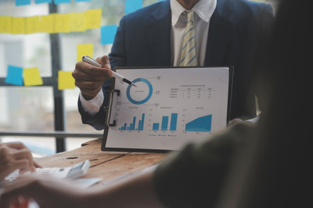 Co working conference, Business team meeting present, investor colleagues discussing new plan financial graph data on office table with laptop and digital tablet, Finance, accounting, investment.の写真素材