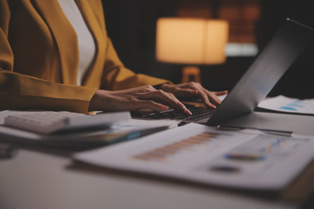 Business woman using calculator for do math finance on wooden desk in office and business working background, tax, accounting, statistics and analytic research conceptの写真素材