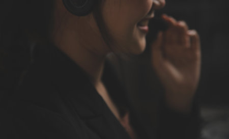 Young woman working in call centre, surrounded by colleaguesの写真素材