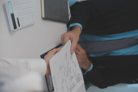 Close up view of job interview in office, focus on resume writing tips, employer reviewing good cv of prepared skilled applicant, recruiter considering application, hr manager making hiring decisionの写真素材