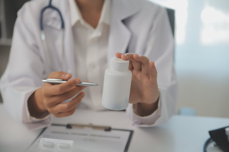 Healthcare service and pharmacy worker with customer at store counter for medication explanation. Pharmaceutical advice and opinion of pharmacist helping girl with medicine information.の写真素材