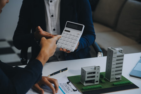 Real estate agent talked about the terms of the home purchase agreement and asked the customer to sign the documents to make the contract legally, Home sales and home insurance concept.の写真素材