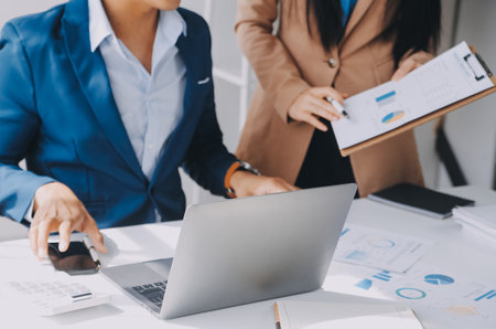 Business team working with new startup project plan and discussion information for financial strategy with laptop and digital tablet in a modern business lounge.の写真素材