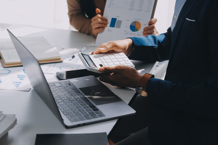 Business team working with new startup project plan and discussion information for financial strategy with laptop and digital tablet in a modern business lounge.の写真素材