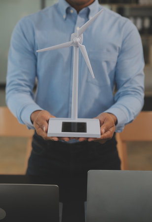 Close-up at tablet, Engineers pointing at tablet with their hands. To jointly design the use of renewable energy with wind and solar energy. Concept of using renewable energy.の写真素材