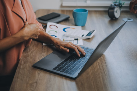 Portrait of Asian young female working on laptop at office