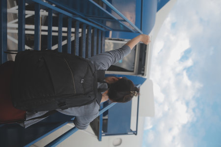 Happy attractive asian woman traveler with backpack at the modern airport terminal, copy space,...