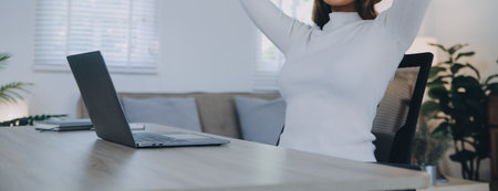 Successful female grapic designer watching tutorial about creative ideas at laptop computer during...