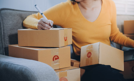 Startup small business entrepreneur or freelance Asian woman using a laptop with box, Young success...