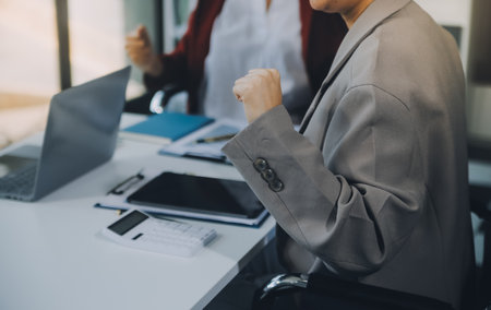Business team working with new startup project plan and discussion information for financial strategy with laptop and digital tablet in a modern business lounge.の写真素材