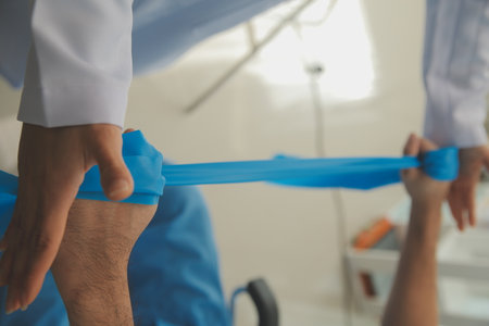 Physiotherapist man giving exercise with dumbbell treatment About Arm and Shoulder of athlete male patient Physical therapy conceptの写真素材