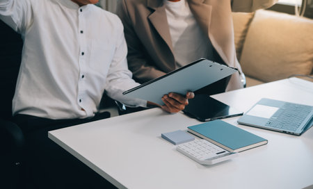 Business team working with new startup project plan and discussion information for financial strategy with laptop and digital tablet in a modern business lounge.の写真素材