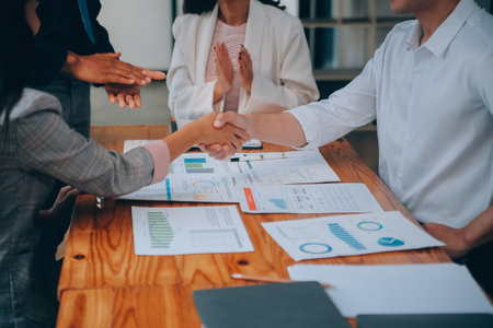 Business success. Business people handshake agreement confirmed in the investment business....