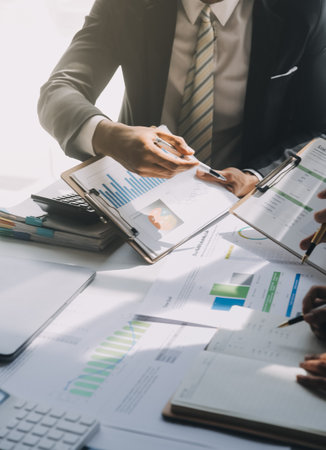Business team meeting present, investor colleagues consultation and conference new strategy plan business and market growth on financial document graph report, Meeting and Talking.の写真素材