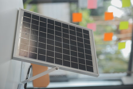 Close-up at tablet, Engineers pointing at tablet with their hands. To jointly design the use of renewable energy with wind and solar energy. Concept of using renewable energy.の写真素材