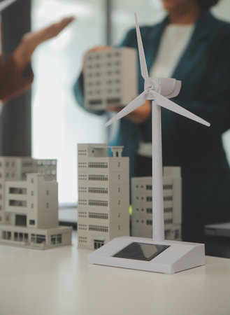 Close-up at tablet, Engineers pointing at tablet with their hands. To jointly design the use of renewable energy with wind and solar energy. Concept of using renewable energy.の写真素材