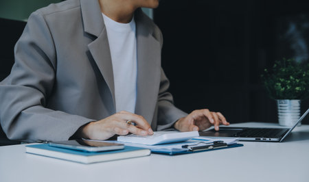 Business Documents, Auditor businesswoman checking searching document legal prepare paperwork or report for analysis TAX time,accountant Documents data contract partner deal in workplace officeの写真素材