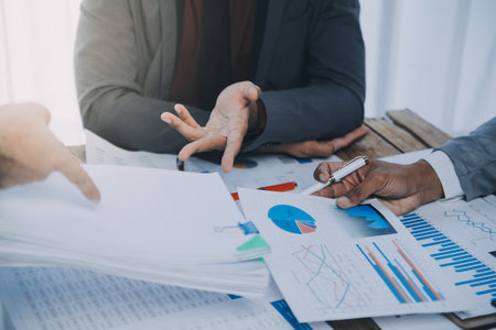 Business idea. Business people talking And calculations about charts and graphs showing the growth of investment results Of successful teamworkの写真素材
