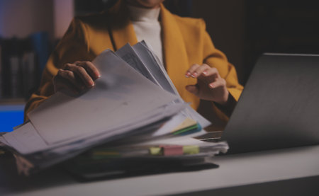 Business woman using calculator for do math finance on wooden desk in office and business working background, tax, accounting, statistics and analytic research conceptの写真素材