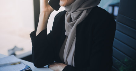 Shot of an attractive mature businesswoman working on laptop in her workstation.の写真素材