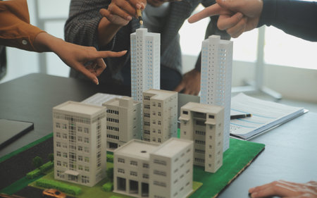 Team of architectures and businessmen discussing and brainstorming on floor plan modification for real estate investment and housing development projectの写真素材