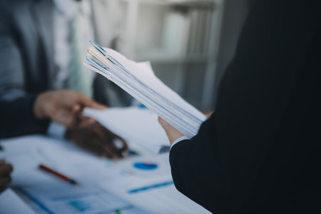 Business idea. Business people talking And calculations about charts and graphs showing the growth of investment results Of successful teamworkの写真素材