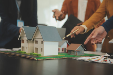 Team of architectures and businessmen discussing and brainstorming on floor plan modification for real estate investment and housing development projectの写真素材