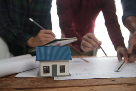Construction and structure concept of Engineer or architect meeting for project working with partner and engineering tools on model building and blueprint in working site, contract for both companies.の写真素材